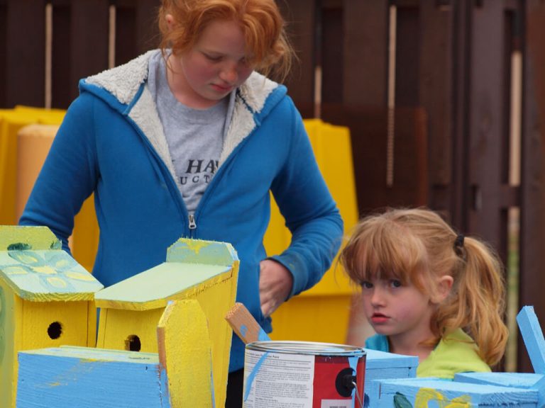 Platte River Basin Environments -two girls help paint birdhouses